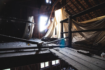 Fototapeta na wymiar sunlight coming through a broken window of an abandoned factory building