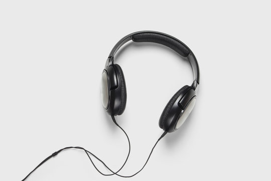 Black headphones audio for listen isolated on soft gray background.