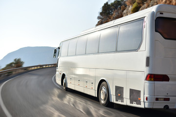 transfer bus for tourists from airport to hotel by mountain road along coast