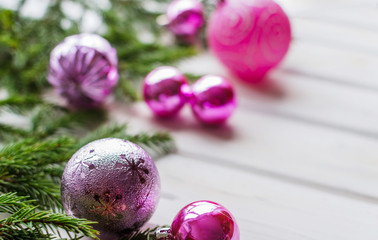 Christmas backdrop with decor and fir tree branch over wooden texture.