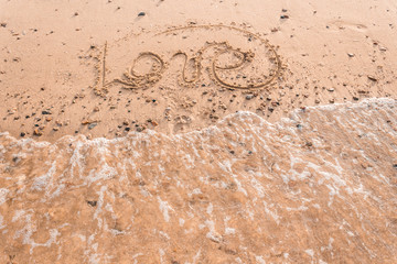 Summer drawn letters on a sandy beach. Text template pattern. Creative typography for holiday greetings.