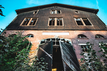 old abandoned factory building with wooden gate