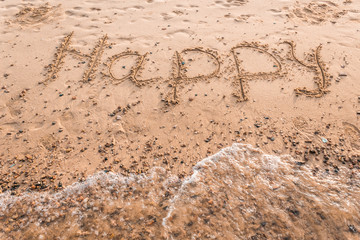 Summer drawn letters on a sandy beach. Text template pattern. Creative typography for holiday greetings.