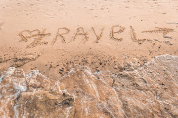 Summer drawn letters on a sandy beach. Text template pattern. Creative typography for holiday greetings.