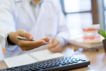 close up on dentist hand trying to explain to patient in office room for healthy teeth concept