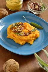 Corn porridge / polenta / with roasted carrots, walnuts and sage, vertical 