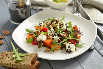 Pumpkin salad with feta, sweet pepper, fresh herbs, almonds and sesame