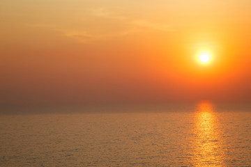 horizontal view of Sunset golden light reflecting on sea wave ripple surface background. Abstract, tranquility, serenity, romance, refresh, relaxation, rest, beauty in nature concept.