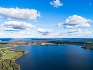 Fototapeta premium Aerial view of seashore with beach, lagoons. Coastline with sand and water. Landscape. Aerial photography. Birdseye. Sky, clouds. Stunning sky clouds. Sky landscape.
