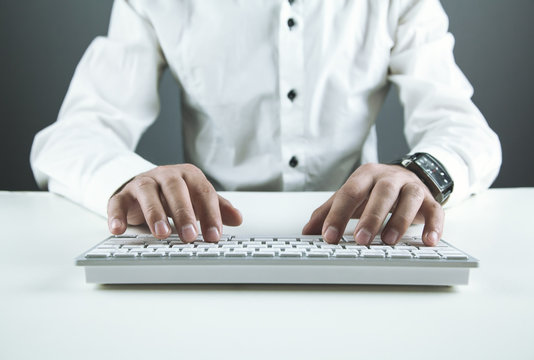 Businessman typing on a computer keyboard . Business concept