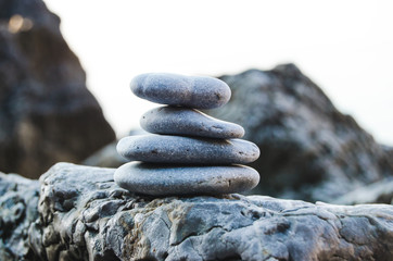 Pebbles from beach of Adriatic sea against mountains.