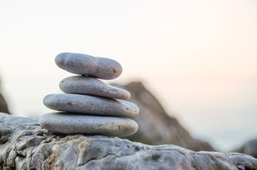 Pebbles from beach of Adriatic sea against mountains.