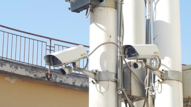 outdoors security camera surveillance installed on concrete urban construction