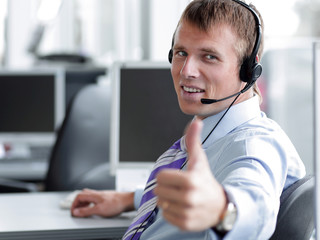 Happy male in headphones gesturing thumb up