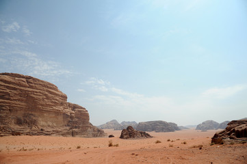 Fototapeta na wymiar Jordanian desert in Wadi Rum, Jordan. Wadi Rum has led to its designation as a UNESCO World Heritage Site. It is known as The Valley of the Moon