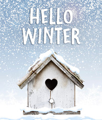 Text hello winter with cute little bird house under snow quote