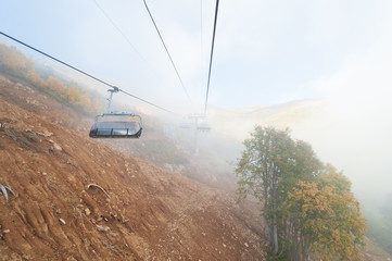 Lifts in the foggy mountains
