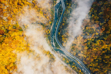Fog on the road aerial view of Jiului Canyon