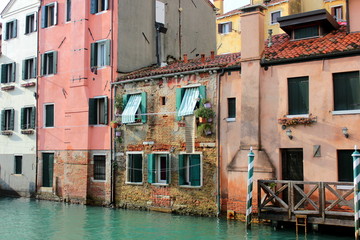 Fototapeta na wymiar The canal in Venice. Ancient houses, reflection in the water.