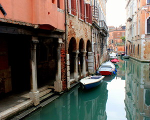 The canal in Venice. Ancient buildings, bridges, boats, reflections in the water