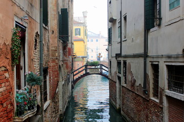 Fototapeta na wymiar The canal in Venice. Ancient buildings, bridges, boats, reflections in the water