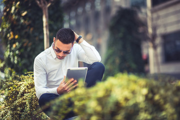 Man looking amazed at his tablet