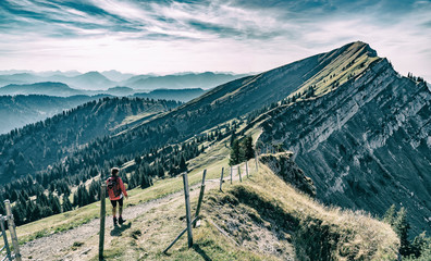 nice senior woman, hiking in fall, autumn  on the ridge of the Nagelfluh chain near Oberstaufen,...