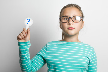 Girl holding a question mark. 