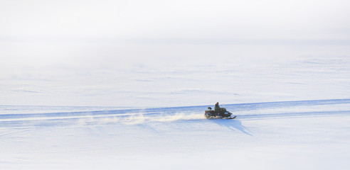 on snowy desert surface to race on all-terrain snowmobile