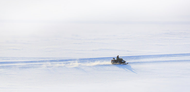on snowy desert surface to race on all-terrain snowmobile