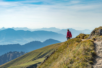 nice senior woman, hiking in fall, autumn  on the ridge of the Nagelfluh chain near Oberstaufen,...