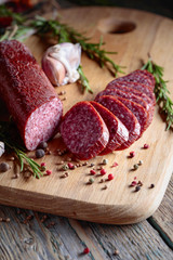 Smoked salami on a old wooden table.