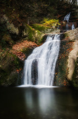 waterfall in the Allgaeu mountains, Bavaria, Germany in autumnal atmosphere with colorful autumn foliage