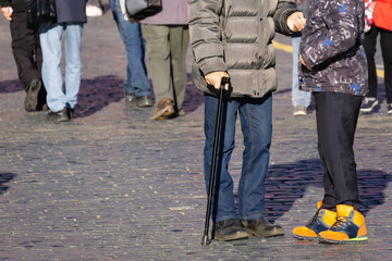 Elderly man standing next to a young boy