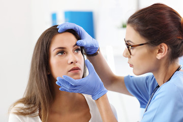 Adult woman having a visit at female oculist's office