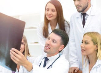 Fototapeta premium group of doctors discussing an x-ray ,sitting at the table.