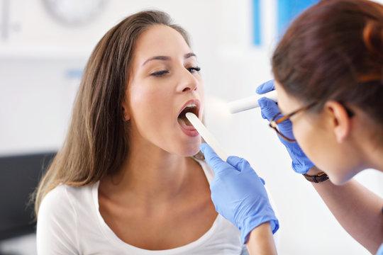 Adult woman having a visit at female laryngologist's office