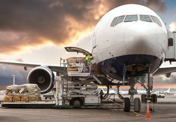 loading cargo into the aircraft before departure with nice sky