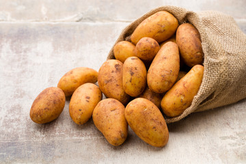 A bio russet potato wooden vintage background.