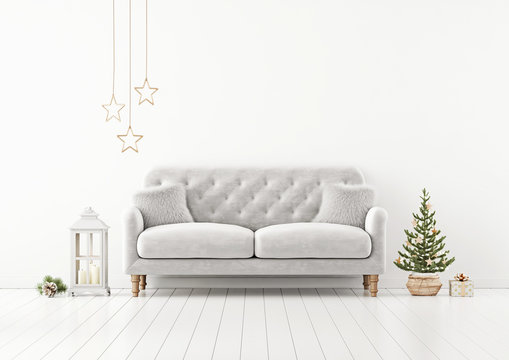 Living room interior wall mock up with grey tufted sofa, fur pillows, lantern and decorated christmas tree on empty white background. 3D rendering.