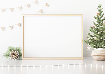 Horizontal poster mock up with golden frame, decorated christmas tree, garland lights and holiday decoration on white wall background. 3D rendering.