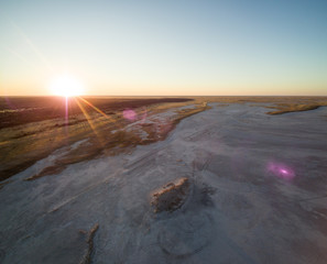 Aerial view of sunset over Tshitane Salt Pan in the salt flats area of Kalahari, Botswana, Africa.