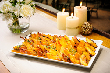 Delicious peach accompaniment roast served fig, pear and rosemary on a ceramic dish. Decorated...