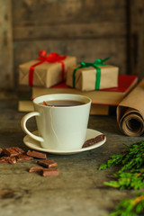 tea in a white cup (tea bag) gifts on the table. holiday atmosphere. top image. food background