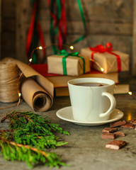 tea in a white cup (tea bag) gifts on the table. holiday atmosphere. top image. food background