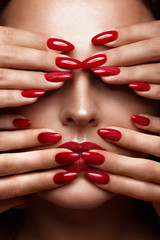 Beautiful girl with a classic make up and multi-colored nails. Manicure design. Beauty face. Photo taken in the studio