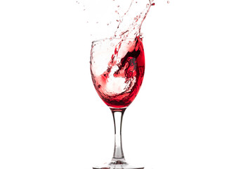 Red wine falls into a glass and creates splash and splashes on a white background.