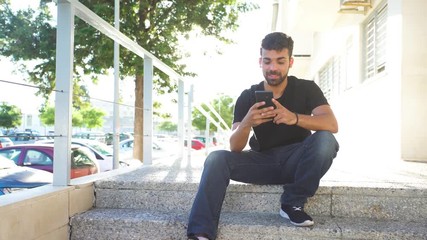 Millenial young man using his smartphone