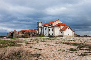 Fototapeta na wymiar Back of the Church of Santuario de Nossa Senhora do Cabo or Pedra Mua Sanctuary. Cabo Espichel Cape. Baroque architecture. Sesimbra, Portugal