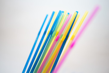 Multiple plastic straws standing straight up